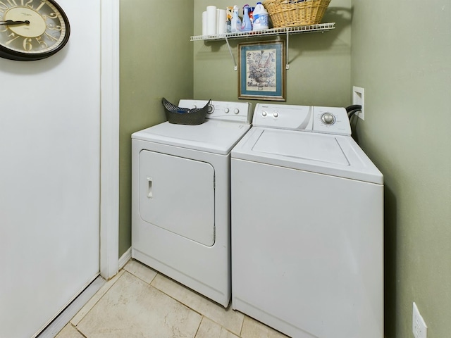 clothes washing area featuring separate washer and dryer and light tile patterned floors