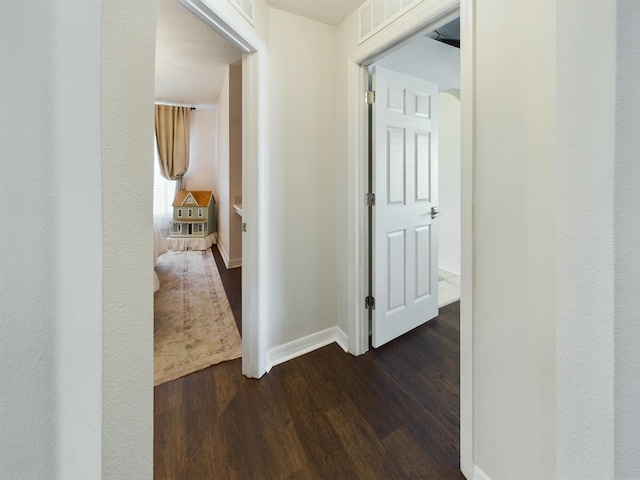 corridor with dark wood-type flooring