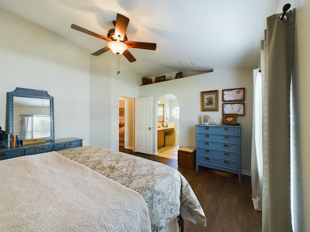 bedroom with dark hardwood / wood-style flooring, ensuite bathroom, vaulted ceiling, and ceiling fan