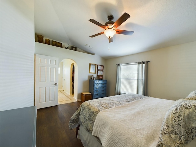 bedroom with hardwood / wood-style flooring, ceiling fan, and vaulted ceiling