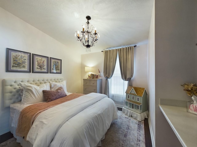 bedroom featuring a notable chandelier and lofted ceiling