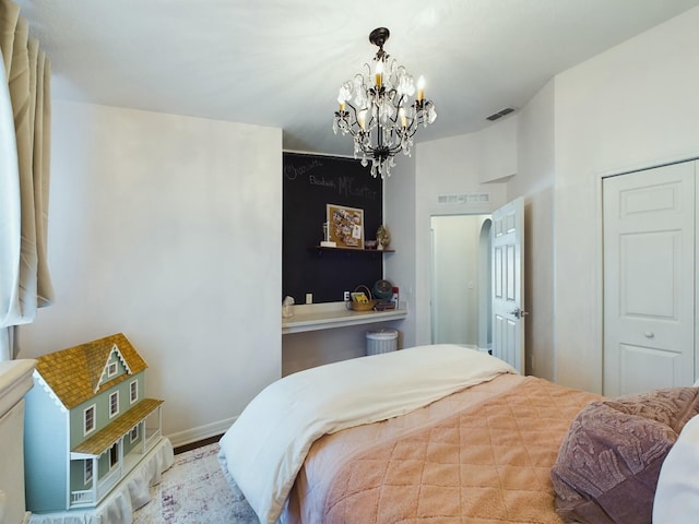 bedroom with a closet and an inviting chandelier