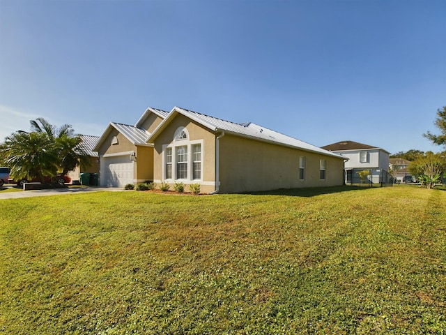 view of property exterior featuring a lawn and a garage