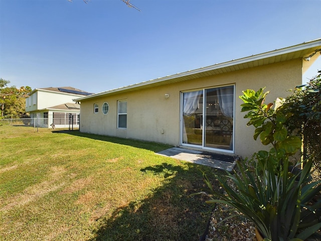 rear view of house featuring a yard