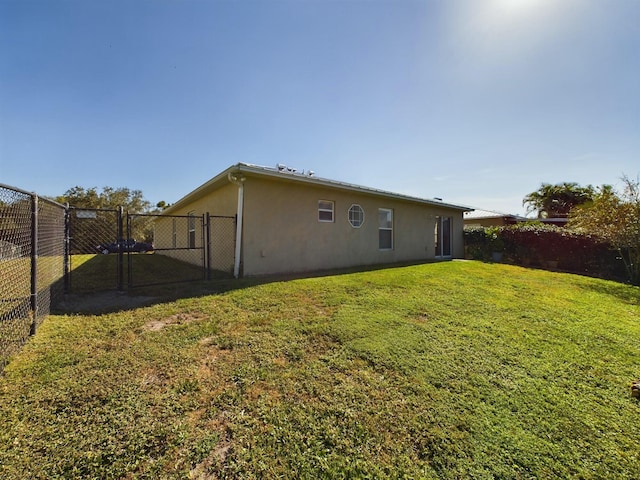 back of property featuring a yard