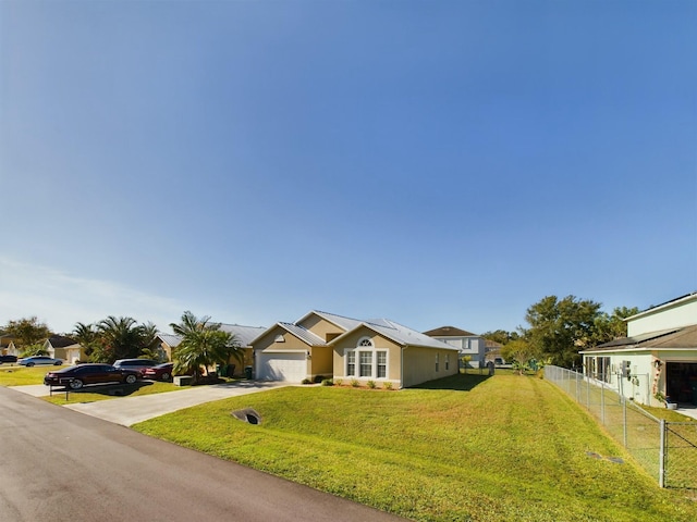 ranch-style house with a front yard and a garage