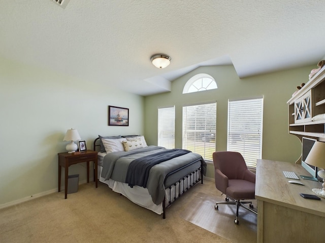 bedroom with light carpet and a textured ceiling