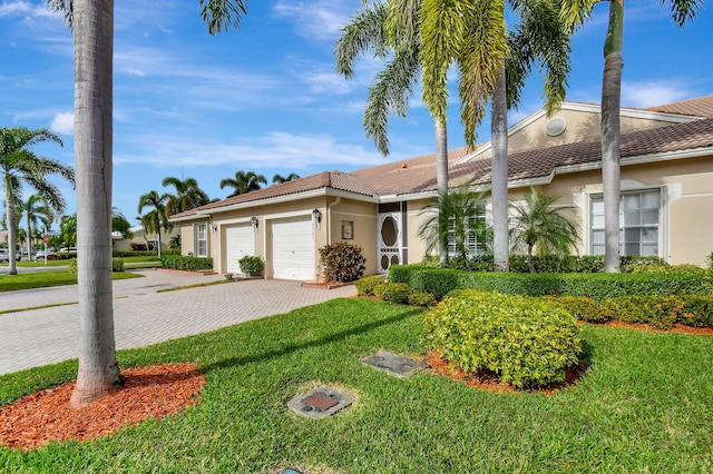 9383 Bridgeport Dr, West Palm Beach, FL 33411 - view of front facade featuring a tile roof, a garage, stucco siding, and a front lawn