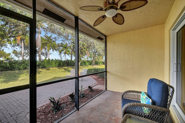 sunroom with a wealth of natural light and ceiling fan