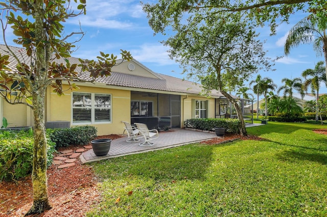 back of house with a patio, a lawn, and central air condition unit