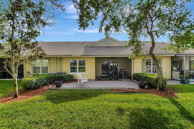 back of house with a patio, a yard, and central AC