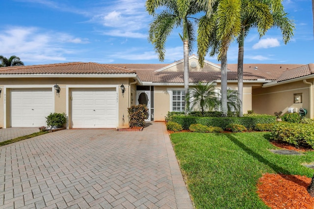 9383 Bridgeport Dr, West Palm Beach, FL 33411 - single story home featuring an attached garage, stucco siding, a tiled roof, decorative driveway, and a front yard