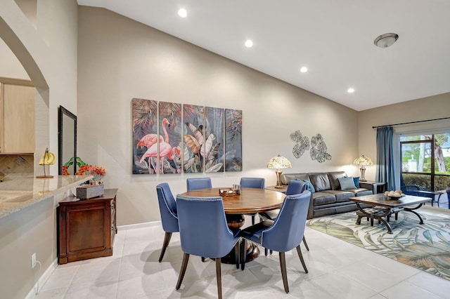 9383 Bridgeport Dr, West Palm Beach, FL 33411 - dining room with arched walkways, light tile patterned flooring, recessed lighting, high vaulted ceiling, and baseboards