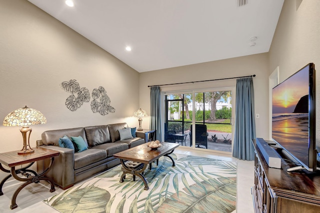 living room featuring lofted ceiling