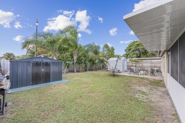 view of yard with a patio and a storage unit