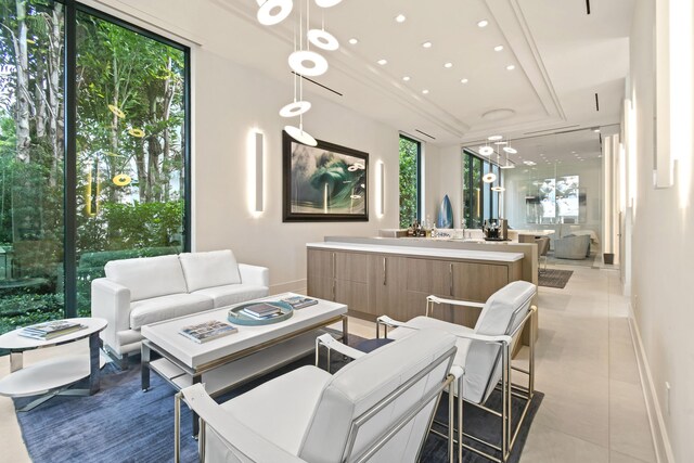 living area featuring light tile patterned floors, baseboards, and recessed lighting