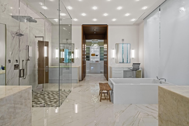 full bath featuring marble finish floor, a freestanding tub, a marble finish shower, and recessed lighting