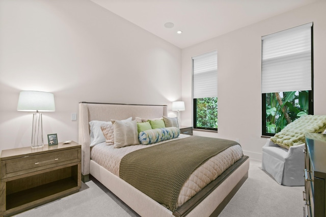 bedroom with recessed lighting, light colored carpet, and baseboards