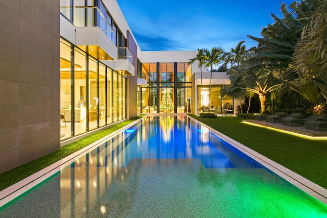 pool at dusk with a yard