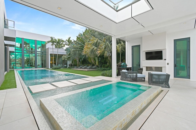 outdoor pool with a patio and outdoor lounge area