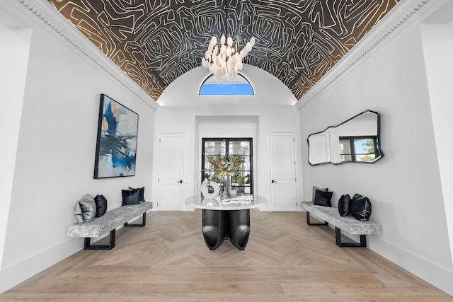 entryway with parquet flooring, a chandelier, and ornamental molding