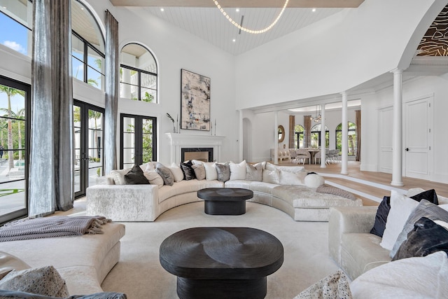 living room featuring plenty of natural light and a towering ceiling