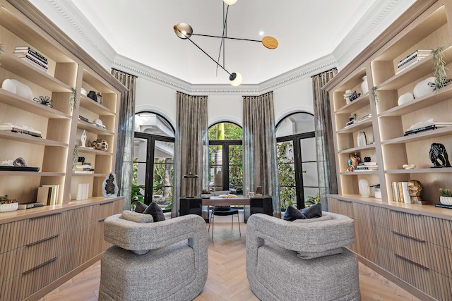 sitting room featuring ornamental molding and french doors