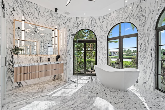 bathroom featuring a washtub and vanity