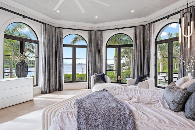 bedroom featuring french doors, a textured ceiling, ceiling fan, and crown molding