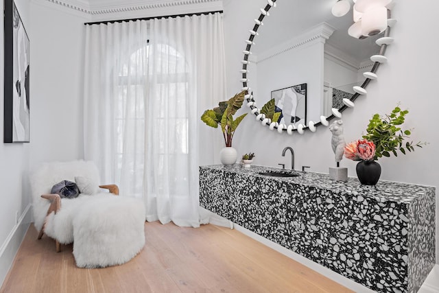 interior space with hardwood / wood-style floors, vanity, and ornamental molding