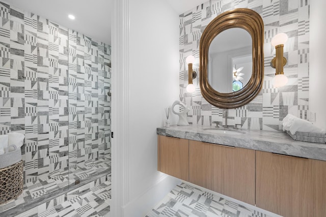 bathroom with tasteful backsplash, tile patterned floors, vanity, and tile walls