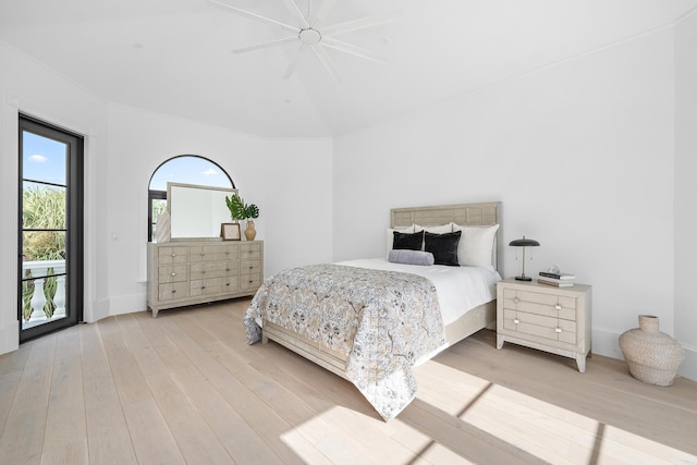 bedroom featuring access to outside, light hardwood / wood-style floors, and ceiling fan