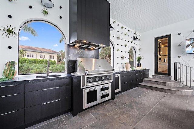 view of patio / terrace with a grill, area for grilling, and sink