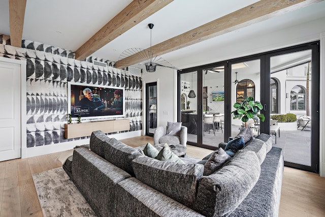 living room featuring beam ceiling and light hardwood / wood-style flooring