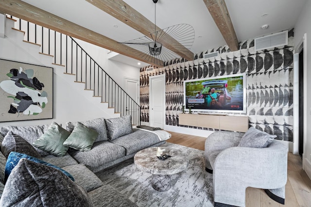 living room with beamed ceiling and hardwood / wood-style floors