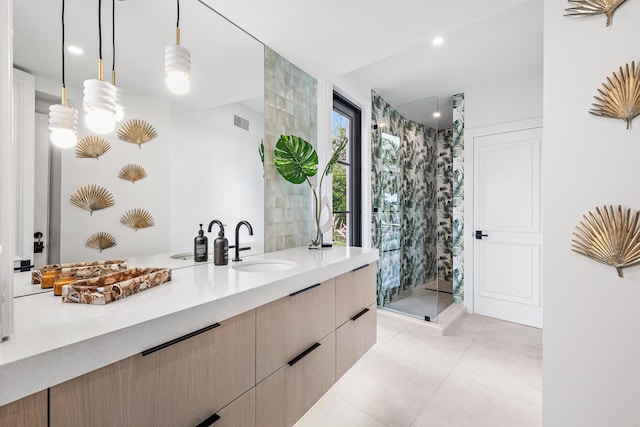 bathroom featuring a shower with door, vanity, and tile patterned flooring