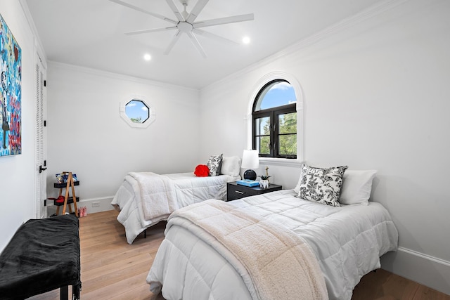 bedroom with ceiling fan, light hardwood / wood-style floors, and ornamental molding