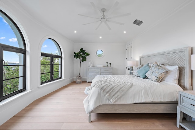 bedroom featuring ceiling fan, light hardwood / wood-style flooring, and ornamental molding