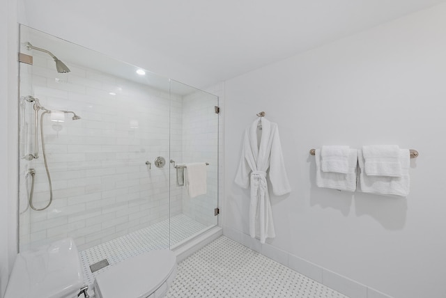 bathroom featuring an enclosed shower and toilet