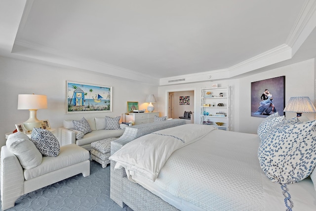 bedroom featuring a raised ceiling, crown molding, and carpet