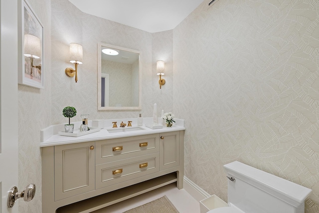 bathroom featuring vanity and toilet