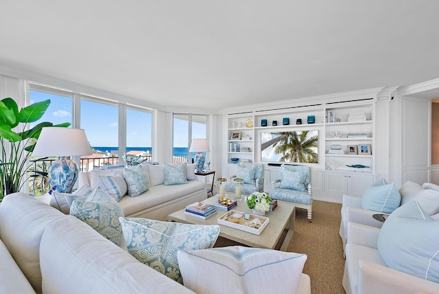 living room with built in shelves and a water view