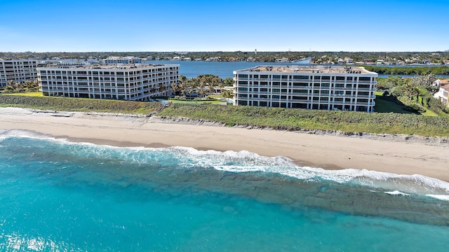 bird's eye view with a water view and a beach view