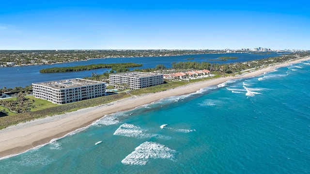 birds eye view of property with a view of the beach and a water view