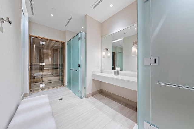 bathroom with vanity and a shower with shower door