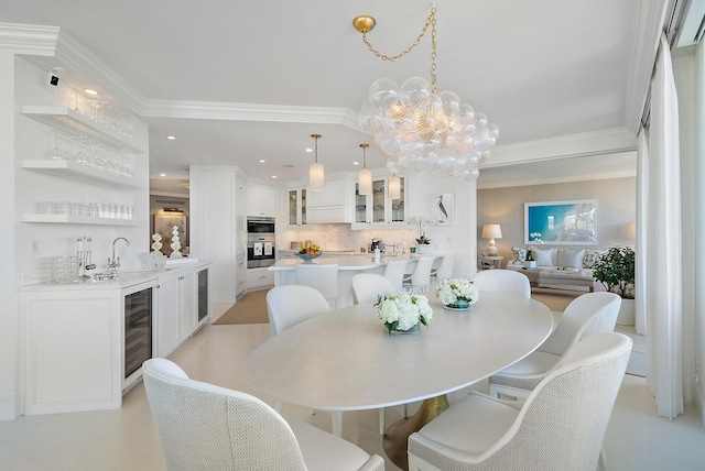 dining area featuring ornamental molding, sink, wine cooler, and an inviting chandelier