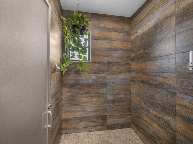 room details featuring wood walls and walk in shower