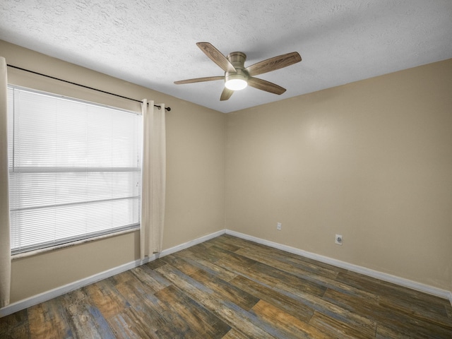 empty room featuring a textured ceiling, dark hardwood / wood-style floors, and ceiling fan