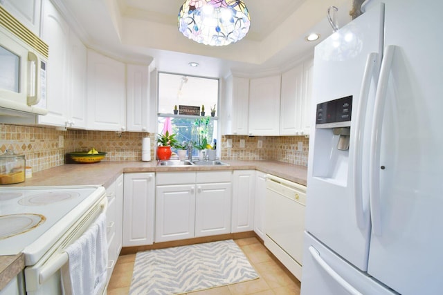 kitchen with white cabinetry, sink, hanging light fixtures, white appliances, and light tile patterned floors