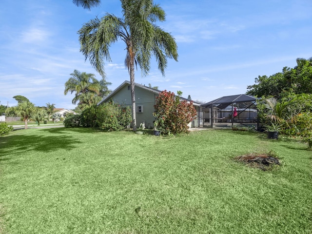 view of yard featuring glass enclosure